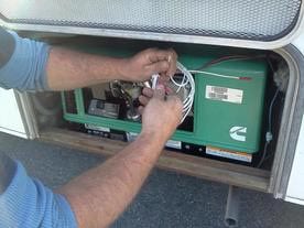 6 E.E.S. Inc. | hands holding wires to a Cummins generator
