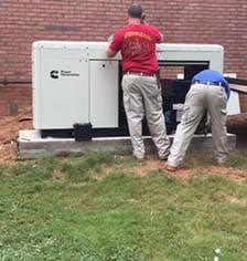 cca99968eaa903e6ca7041c15301f0af E.E.S. Inc. | two men working on a large generator outside of a commercial property
